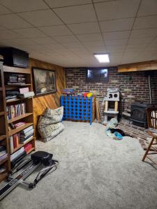 a living room with a brick wall at Cozy Hideaway in Lewiston