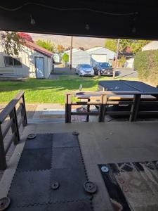 a ping pong table and benches in a yard at Cozy Hideaway in Lewiston +1 photo