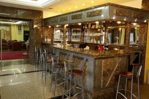 a bar in a hotel with stools in a room at Kayhanbey Hotel in Kusadası