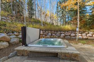 ein Whirlpool auf einer Steinplatte in der Unterkunft West Vail Retreat Steps to Ski plus Private Hot Tub in Vail