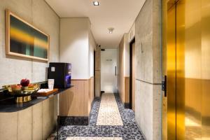 a corridor of a hotel room with a hallway at Rodona Hotel in Mexico City +3 photos