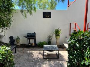 a patio with two chairs and a table and a piano at Apartment Rosarito Beach Downtown (D) in Rosarito