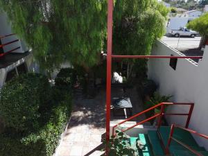 an overhead view of a garden with a red railing at Apartment Rosarito Beach Downtown (D) in Rosarito +4 photos