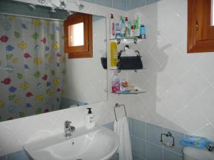 a bathroom with a sink and a shower curtain at Paraíso Veracoast in Vera +31 photos