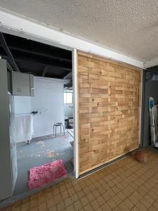 a room with a wooden sliding door in a room at Hotu's Bungalow in Papeete