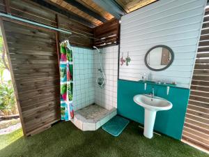 a bathroom with a shower and a sink at Hotu's Bungalow in Papeete