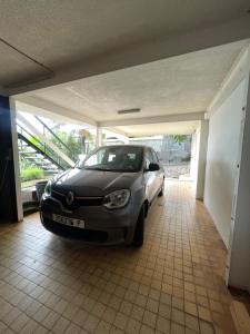 a car is parked in a garage at Hotu's Bungalow in Papeete