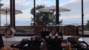 a table full of food with a view of the ocean at Yuinoya MITSUBACHI in Imabari