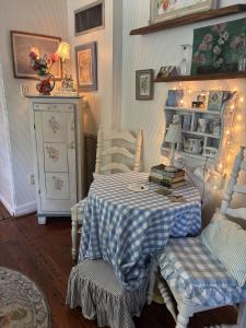 a dining room with a table and two chairs and a table with a table at 3BR 2BA Historic Mid City family BACH parties FQ!! in New Orleans