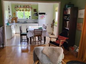 a kitchen and dining room with a table and chairs at Cozy Getaway near Forest and Lake in Insjön