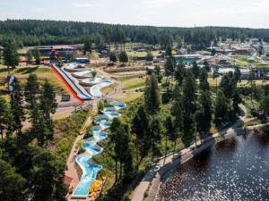an aerial view of a water park with a river at Cozy Getaway near Forest and Lake in Insjön