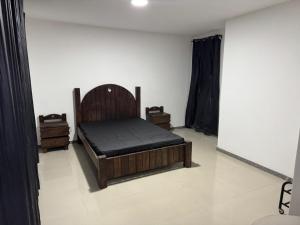 a bedroom with a bed and two night stands at Village Pedra do Sal Lounge Apts in Salvador