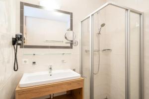 a bathroom with a sink and a shower at Landal Brandnertal in Bürserberg