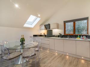 a kitchen with a glass table and a sink at Waterside Lodge in Elland