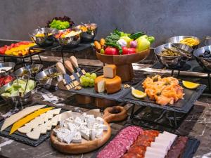 a table topped with lots of cheese and other foods at Tbilisi Philharmonic Hotel by Mercure in Tbilisi City