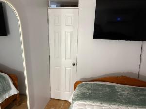 a bedroom with a bed and a flat screen tv at Cocobeach Cabin no pets allowed in Rio Grande
