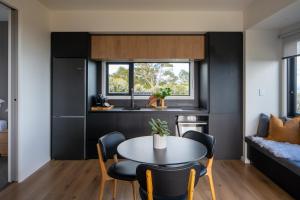 a kitchen and living room with a table and chairs at Mountain Rise Retreat in Cambridge