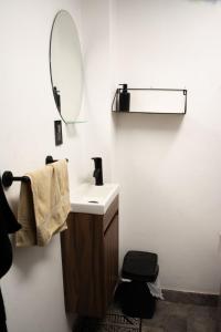a bathroom with a sink and a mirror at Departamento Azul Roma in Cedro +23 photos