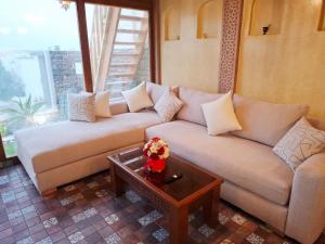 a living room with two couches and a coffee table at Rooftop terasse azur essaouira in Essaouira