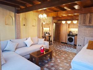 a living room with a couch and a table at rooftop studio essaouira in Essaouira