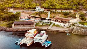 a group of boats are docked in a harbor at Pousada Lampião Rio in Piranhas
