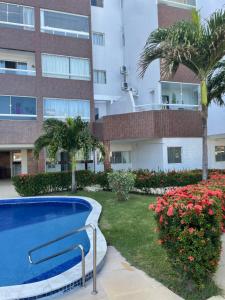 a swimming pool in front of a building at Flat Luxxor 50 metros da praia Jacumã in Conde +19 photos