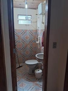 a bathroom with a toilet and a sink at Pousada da Lu in São Francisco do Sul