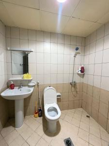 a bathroom with a toilet and a sink at Chill Studio apartments Al rigga Dubai in Dubai