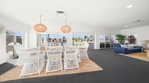 a kitchen and living room with a table and chairs at Hibbard Waterfront Escape in Port Macquarie