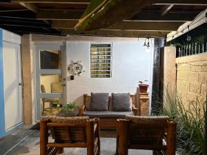 a patio with a couch and two chairs at Cocobeach Cabin no pets allowed in Rio Grande