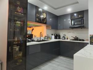 a kitchen with black cabinets and white counter tops at Penthouse with Jacuzzi in Guarne in Guarne +8 photos