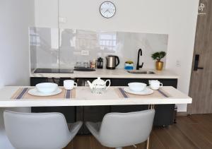 a kitchen with a table and two white chairs at Quinta Park 43 in Bogotá