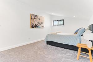 a bedroom with a bed and a picture on the wall at Homestead on Fennell - Fresh Eggs, Farm & BBQ Fun in Toronto