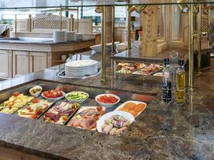 a buffet line with many different types of food at Atomis Hotel Munich Airport by Mercure in Oberding