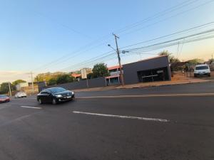een zwarte auto rijdt door een straat bij Hotel Indubrasil Campo Grande LDTA in Campo Grande