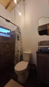 a bathroom with a toilet and a shower at Glamping La Villa in Guatavita