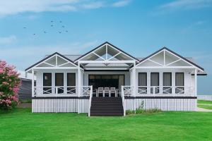 a rendering of a white house with a lawn at Homestead on Fennell - Fresh Eggs, Farm & BBQ Fun in Toronto