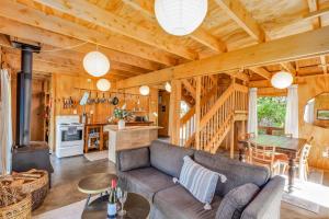 a living room with a couch and a table at The Gatehouse - Tata Headlands in Tata Beach