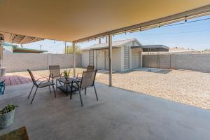 a patio with a table and chairs and a house at ASU-Mesa Getaway-Stylish & Relaxing in Mesa
