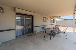 a patio with chairs and a table and a window at ASU-Mesa Getaway-Stylish & Relaxing in Mesa