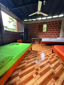 a room with two beds and a ceiling fan at Casa Cachalote in El Valle +65 photos
