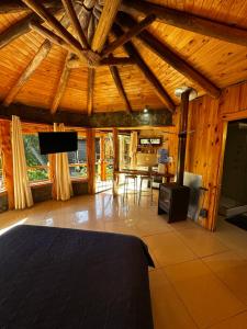 a large room with a bed and a dining room at Reserva los Bollenes in Constitución