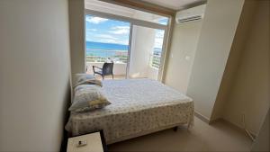 Un dormitorio con una cama y vista al mar. en Ocean Club Apartment - Atlantic Tower, en Playas