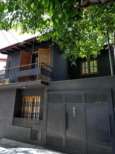 a house with a garage door and a balcony at Rincón de Arístides in Mendoza