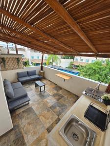 une terrasse extérieure avec un évier et un toit dans l'établissement Casa Tulipanes Morelos, Alberca, Jacuzzi, AC, WiFi, à Morelos