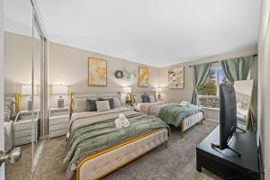 une chambre avec deux lits et une télévision à écran plat dans l'établissement Entire Private 2BR-1Bth King Bed, Pool, HotTub, 2 Parkings, Mira Mesa, Available Now, à San Diego