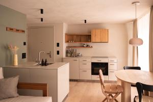a kitchen and dining room with a table and a counter at normalkonsum - premium apartments in St. Gallen