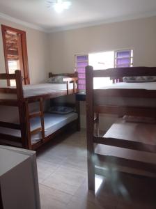 a room with three bunk beds and a window at Casa Freire in Lavras
