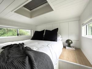 a bedroom with a bed with a blanket on it at Atherton Tiny - Retreat with Fire Pit in Atherton +14 photos
