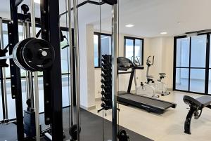 a fitness room with treadmills and a gym at Apartamento na Praia dos Milionários - 100M do Mar in Cururupe